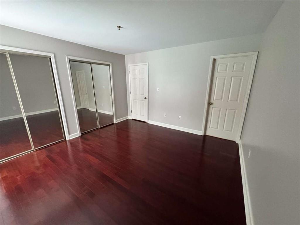 3201 Lenox Road Northeast, Unit 2 Atlanta, GA 30324 - Photo 13 of 39 an empty room with wooden floor and windows