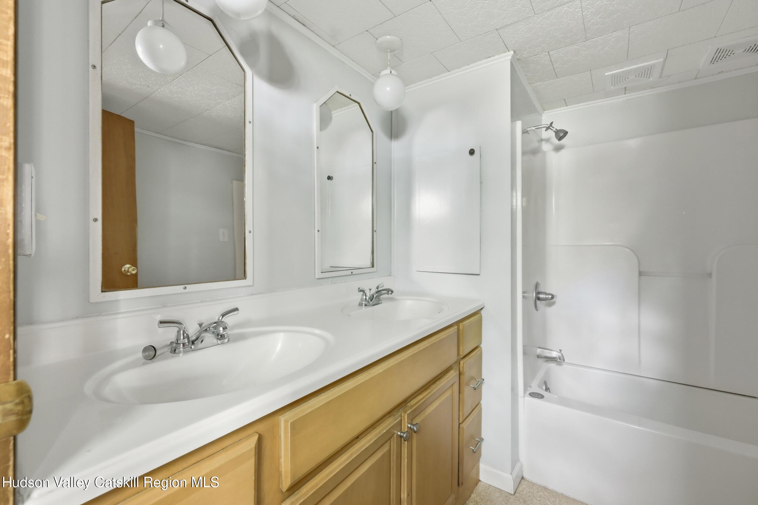 294 Kyserike Road Accord, NY 12404 - Photo 31 of 46 a bathroom with a granite countertop sink mirror and a shower
