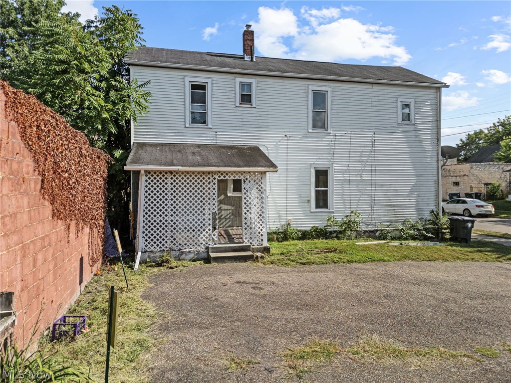 2387 29th Street Southwest Akron, OH 44314 - Photo 13 of 24 Rear view of house with a chimney