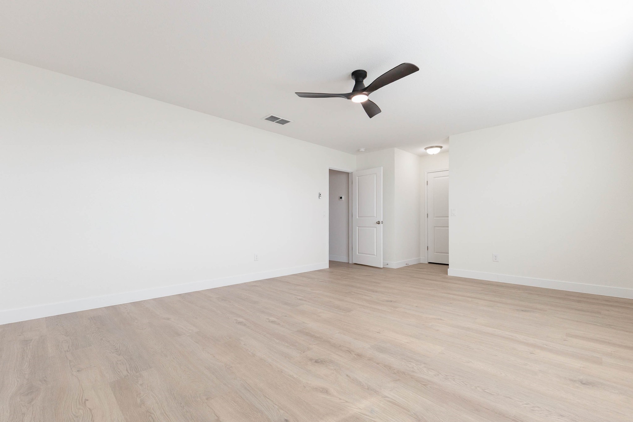 331 Seneca Loop Kyle, TX 78640 - Photo 13 of 29 The primary suite offers generous proportions and a modern ceiling fan, creating a true retreat at the end of the day.
