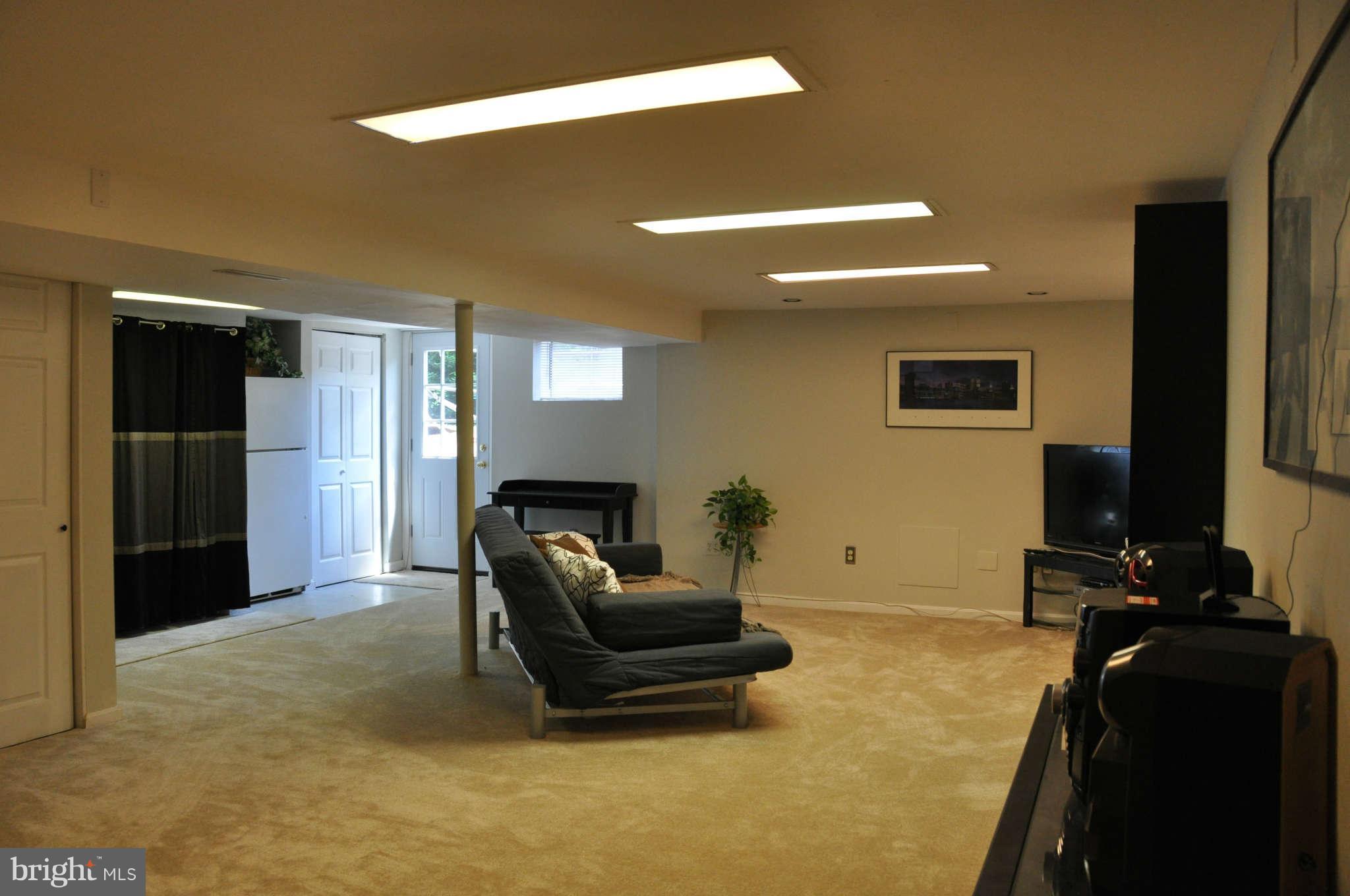 5507 Yorkshire Street Springfield, VA 22151 - Photo 12 of 26 a living room with furniture and a flat screen tv