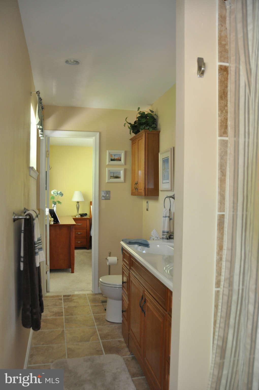5507 Yorkshire Street Springfield, VA 22151 - Photo 17 of 26 a bathroom with a granite countertop sink a toilet and shower
