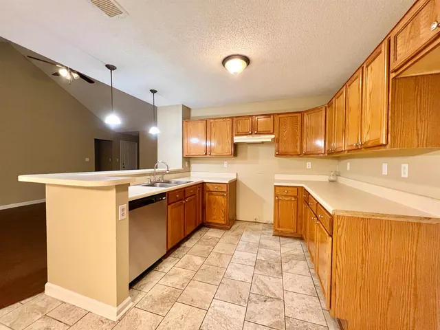 a kitchen with stainless steel appliances granite countertop a sink and cabinets