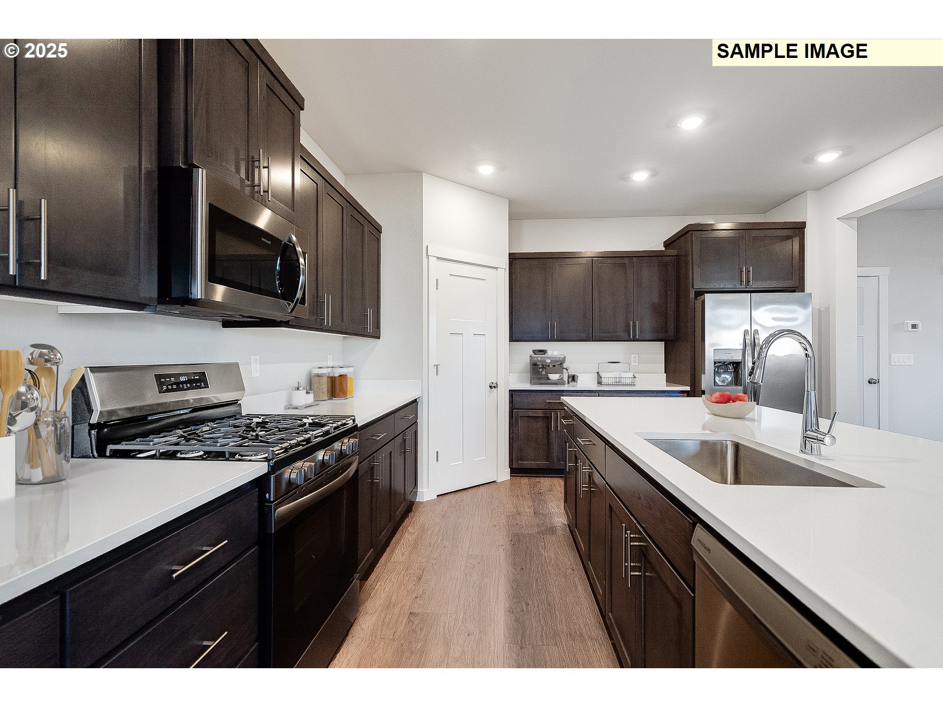 5893 Bainbridge Road Eugene, OR 97402 - Photo 3 of 22 a kitchen with stainless steel appliances a sink dishwasher a stove top oven a refrigerator with island and chairs