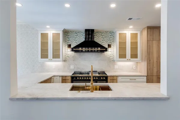 a kitchen with a stove and a white cabinet