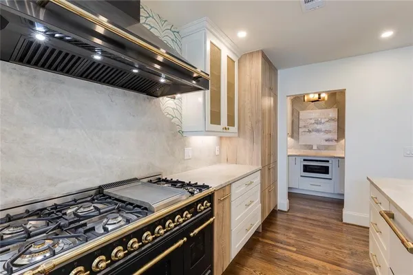 a kitchen with stainless steel appliances a stove and a refrigerator