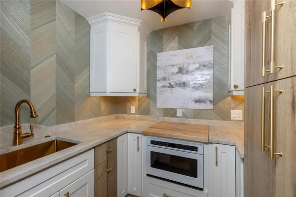 a view of a kitchen with a sink and cabinets
