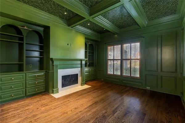 a view of an empty room with a fireplace and a window