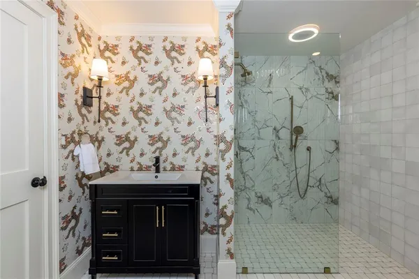 a bathroom with a granite countertop shower a sink and a shower curtain