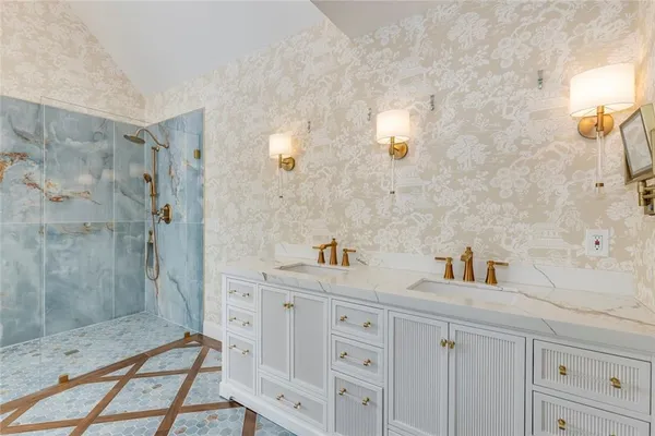 a bathroom with a sink a mirror and a shower