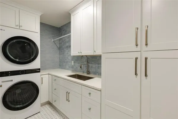 a utility room with sink dryer and washer