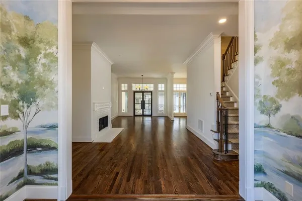 a view of an entryway with wooden floor and door