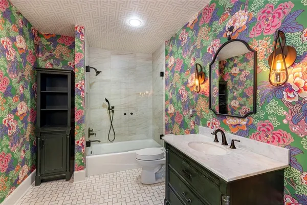 a bathroom with a sink mirror vanity and toilet