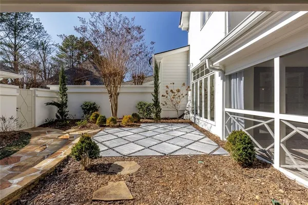a backyard of a house with table and chairs