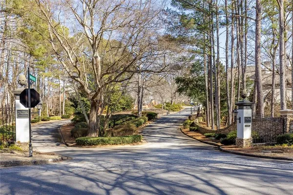 a view of a park with bench and trees