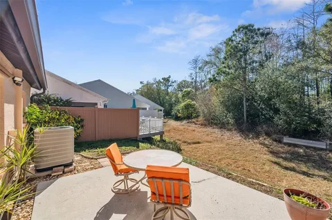 a backyard of a house with table and chairs