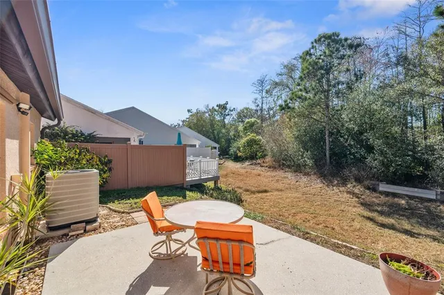 a backyard of a house with yard and outdoor seating