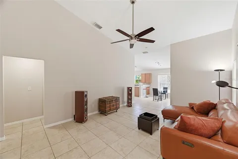 a room with furniture and a ceiling fan