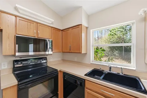 a kitchen that has a sink and a stove