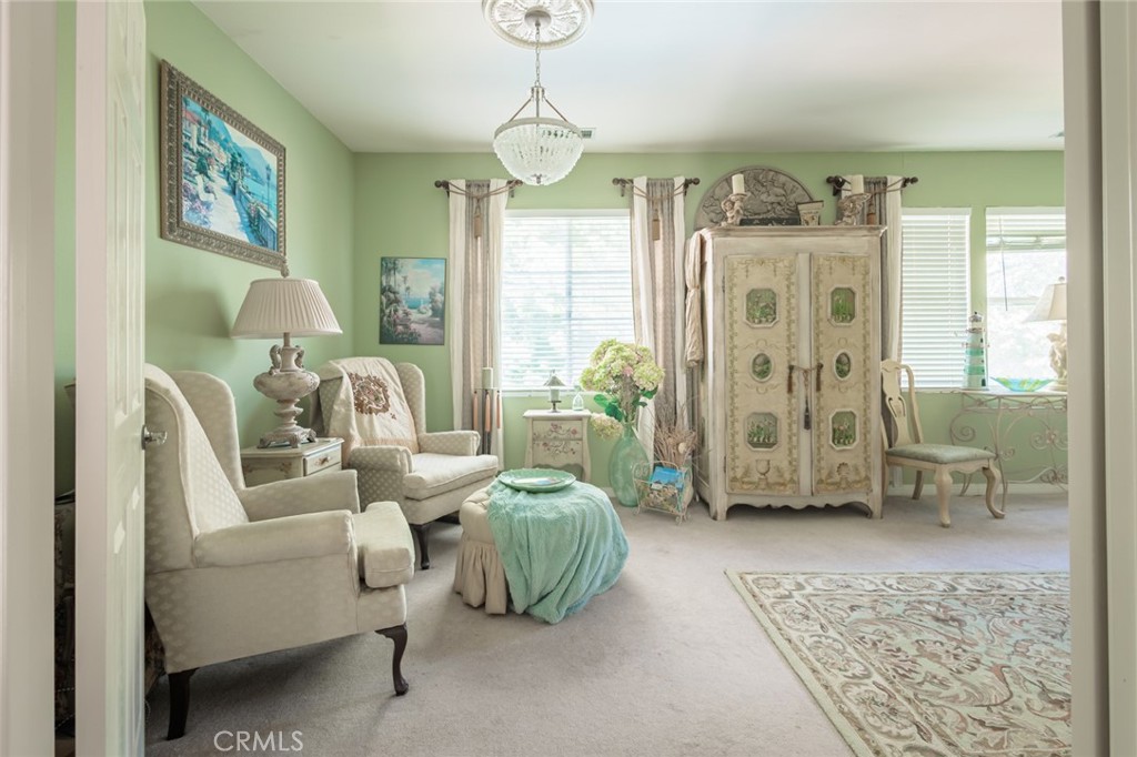 1045 Inverlochy Drive Fallbrook, CA 92028 - Photo 12 of 39 a living room with furniture a chandelier and a window