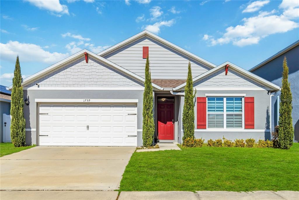 1759 Copinger Terrace Kissimmee, FL 34744 - Photo 1 of 29 a view of a house with a yard and garage