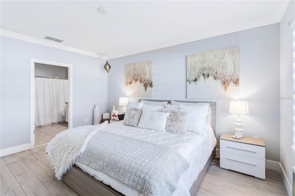 1759 Copinger Terrace Kissimmee, FL 34744 - Photo 15 of 29 a bedroom with a bed and a painting on the wall