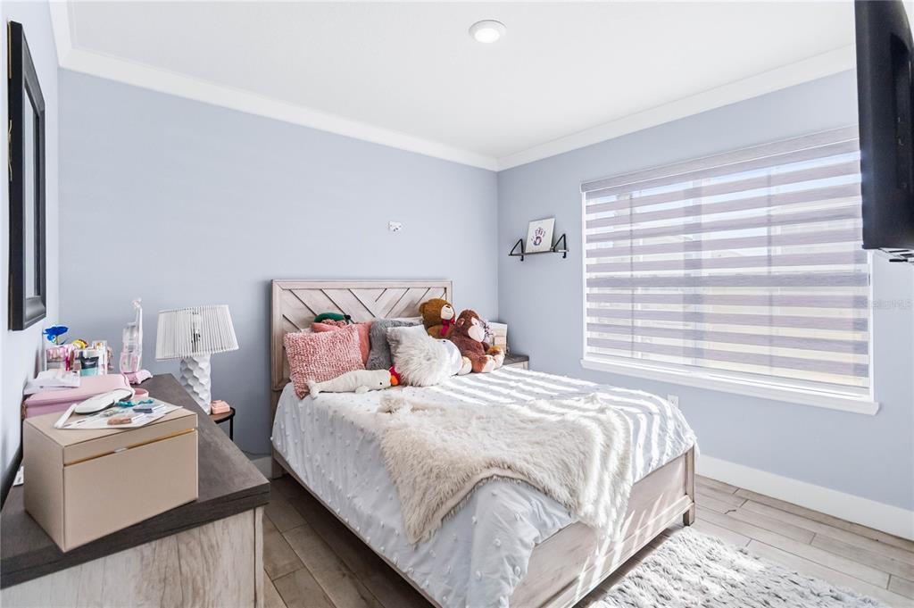1759 Copinger Terrace Kissimmee, FL 34744 - Photo 17 of 29 a bedroom with a bed and a window