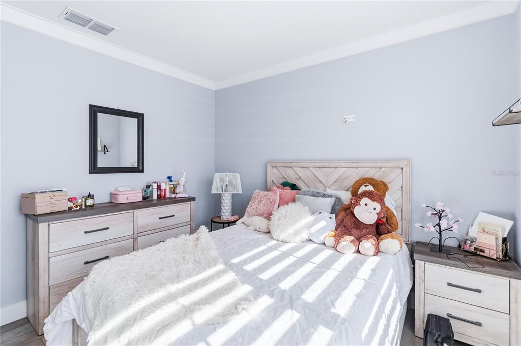 1759 Copinger Terrace Kissimmee, FL 34744 - Photo 18 of 29 a bedroom with a bed and a table in it
