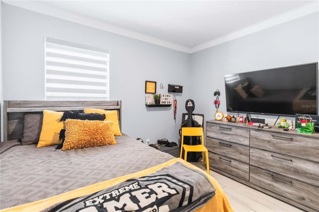 1759 Copinger Terrace Kissimmee, FL 34744 - Photo 20 of 29 a bedroom with bed and tv