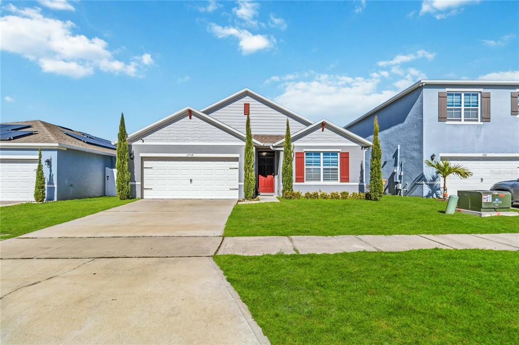 1759 Copinger Terrace Kissimmee, FL 34744 - Photo 5 of 29 a front view of a house with a garden and yard