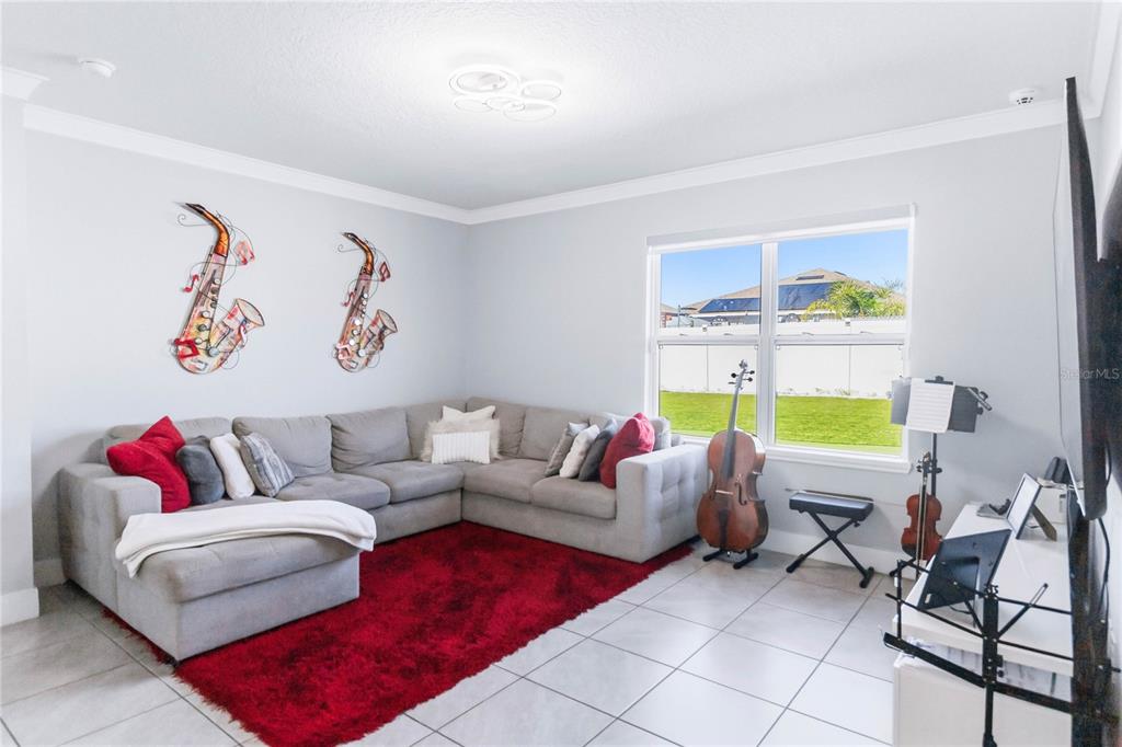 1759 Copinger Terrace Kissimmee, FL 34744 - Photo 7 of 29 a living room with furniture and a window