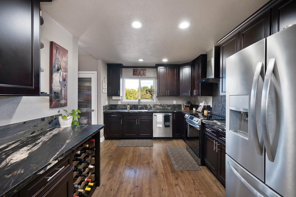 2378 Cascade Trail Cool, CA 95614 - Photo 15 of 57 a kitchen with stainless steel appliances a refrigerator sink stove microwave and cabinets