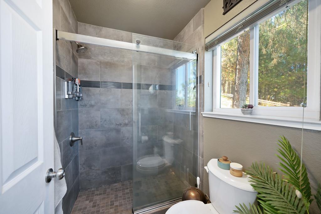 2378 Cascade Trail Cool, CA 95614 - Photo 22 of 57 a bathroom with a shower a toilet and a shower