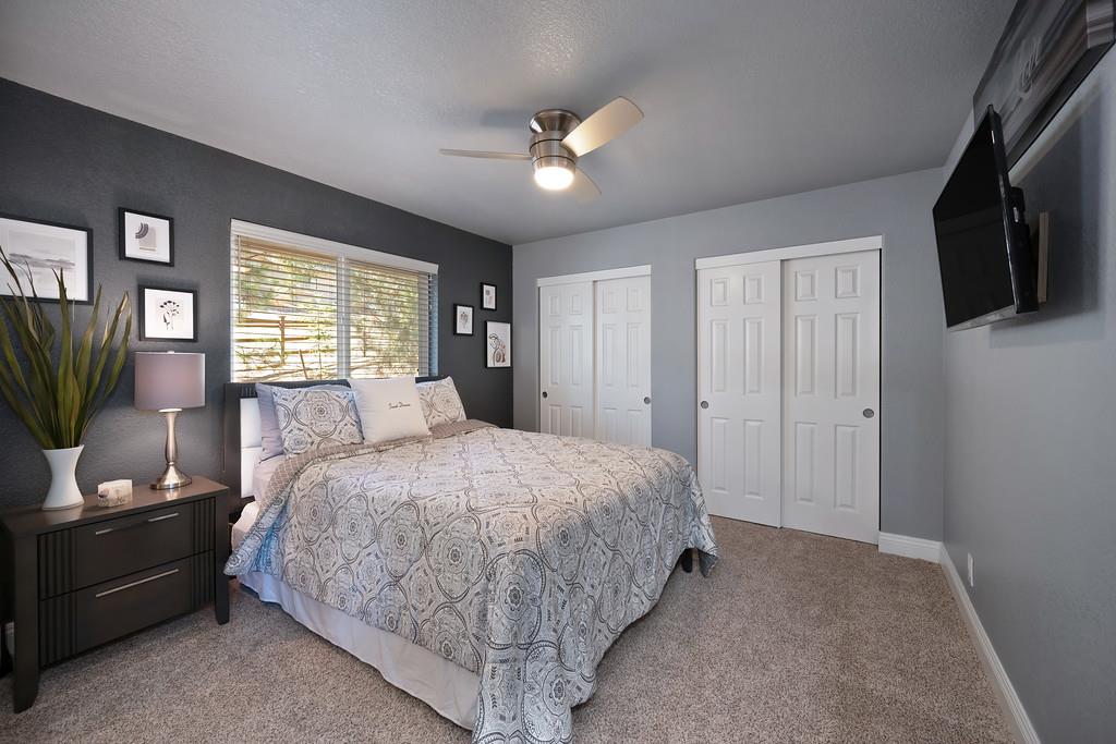 2378 Cascade Trail Cool, CA 95614 - Photo 33 of 57 a bedroom with a large bed and flat screen tv