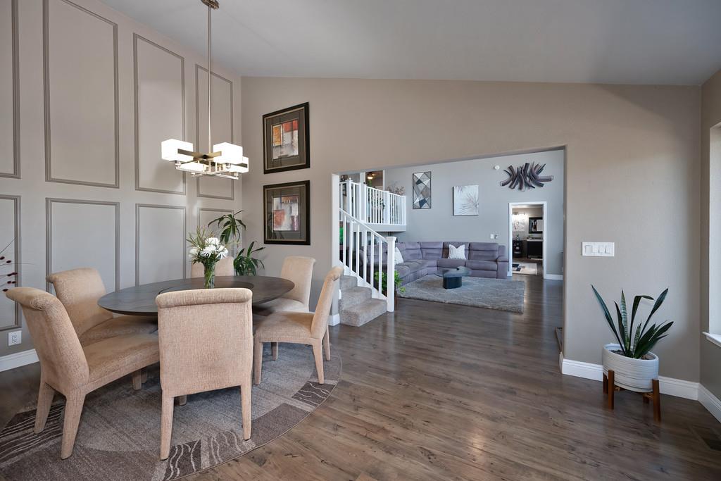 2378 Cascade Trail Cool, CA 95614 - Photo 7 of 57 a living room with furniture a chandelier and a dining table