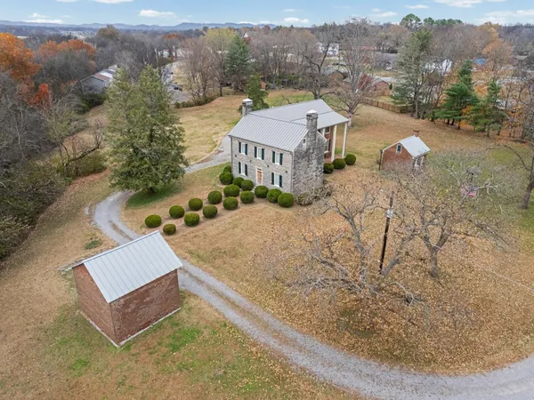 an aerial view of a house with a yard and balcony