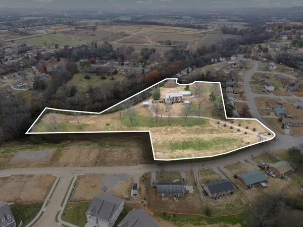 a bedroom with a bed a dresser and chair