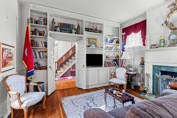 a living room with patio furniture and a chandelier
