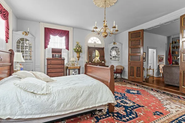 a view of a dining room with furniture and a chandelier