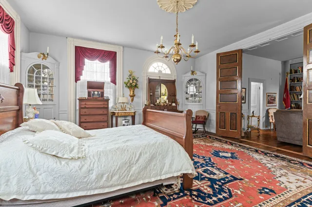 a view of a dining room with furniture and a chandelier