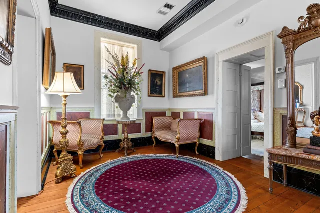 a living room with furniture a rug and a window