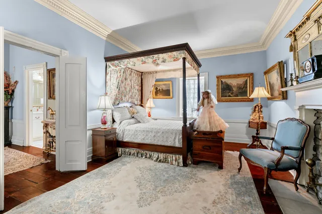 a view of a bedroom with furniture and wooden floor