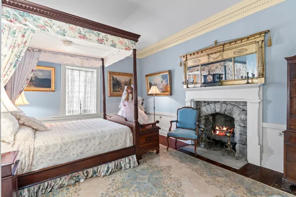 a view of a bedroom with furniture and windows