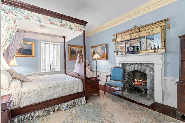 a view of a bedroom with furniture and windows