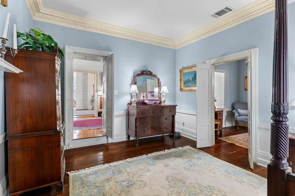 a living room with lots of furniture and a painting on the wall