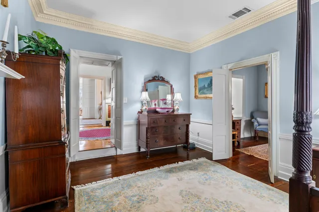 a living room with lots of furniture and a painting on the wall