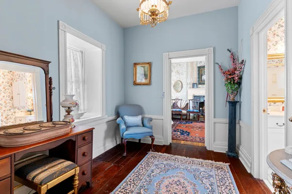 a living room with furniture and a painting on the wall
