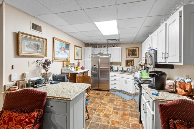 a view of a brick house with a large windows and a yard