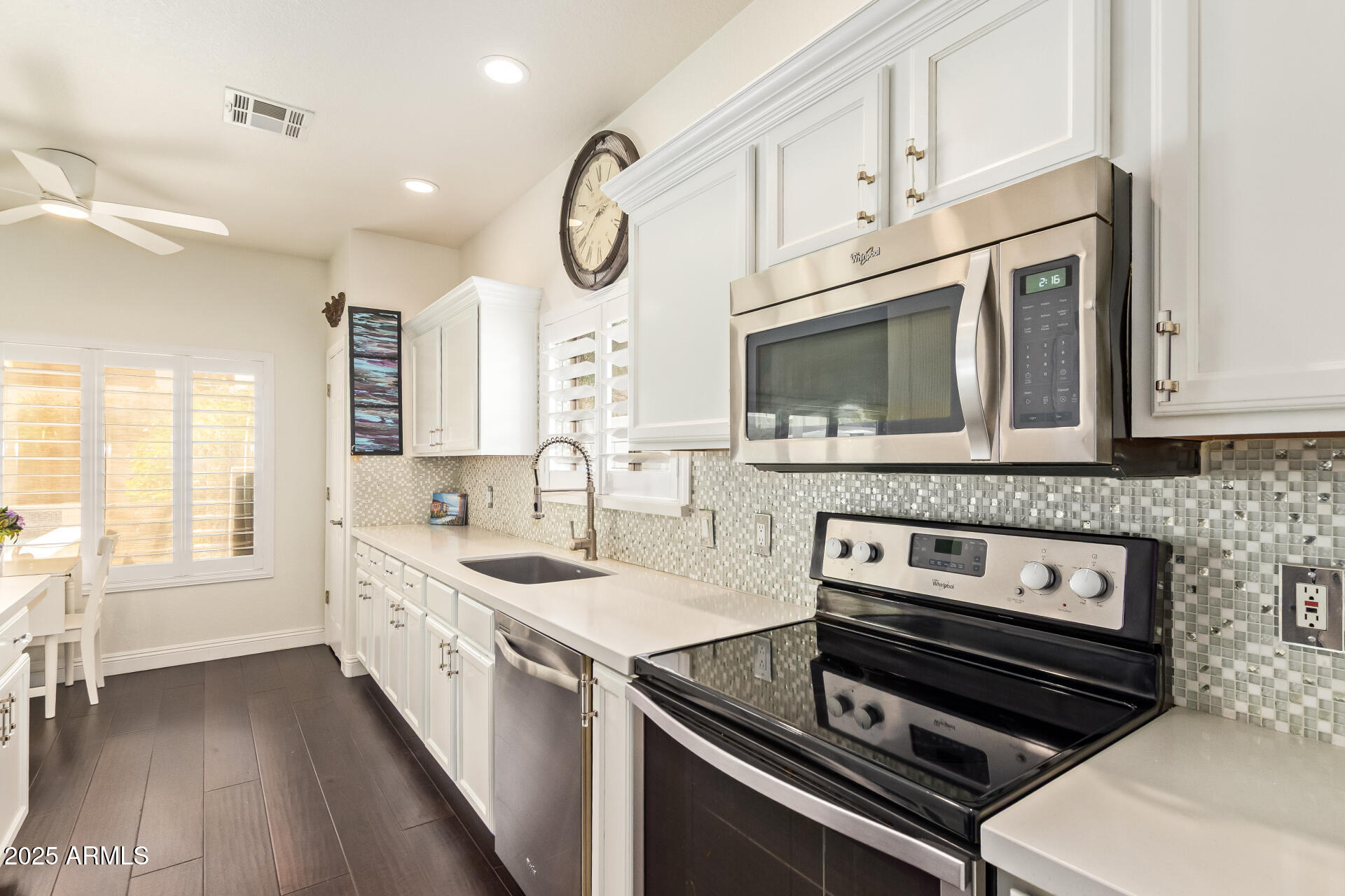 19606 North 23rd Way Phoenix, AZ 85024 - Photo 18 of 41 a kitchen with stainless steel appliances a stove a sink and a microwave