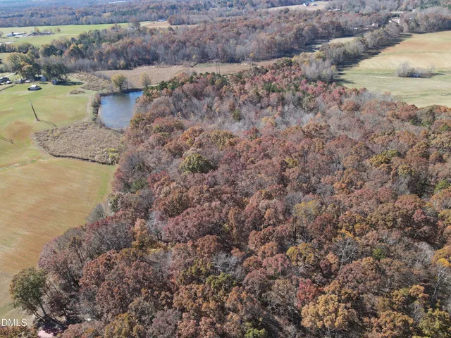 a bird view of a house next to a lake